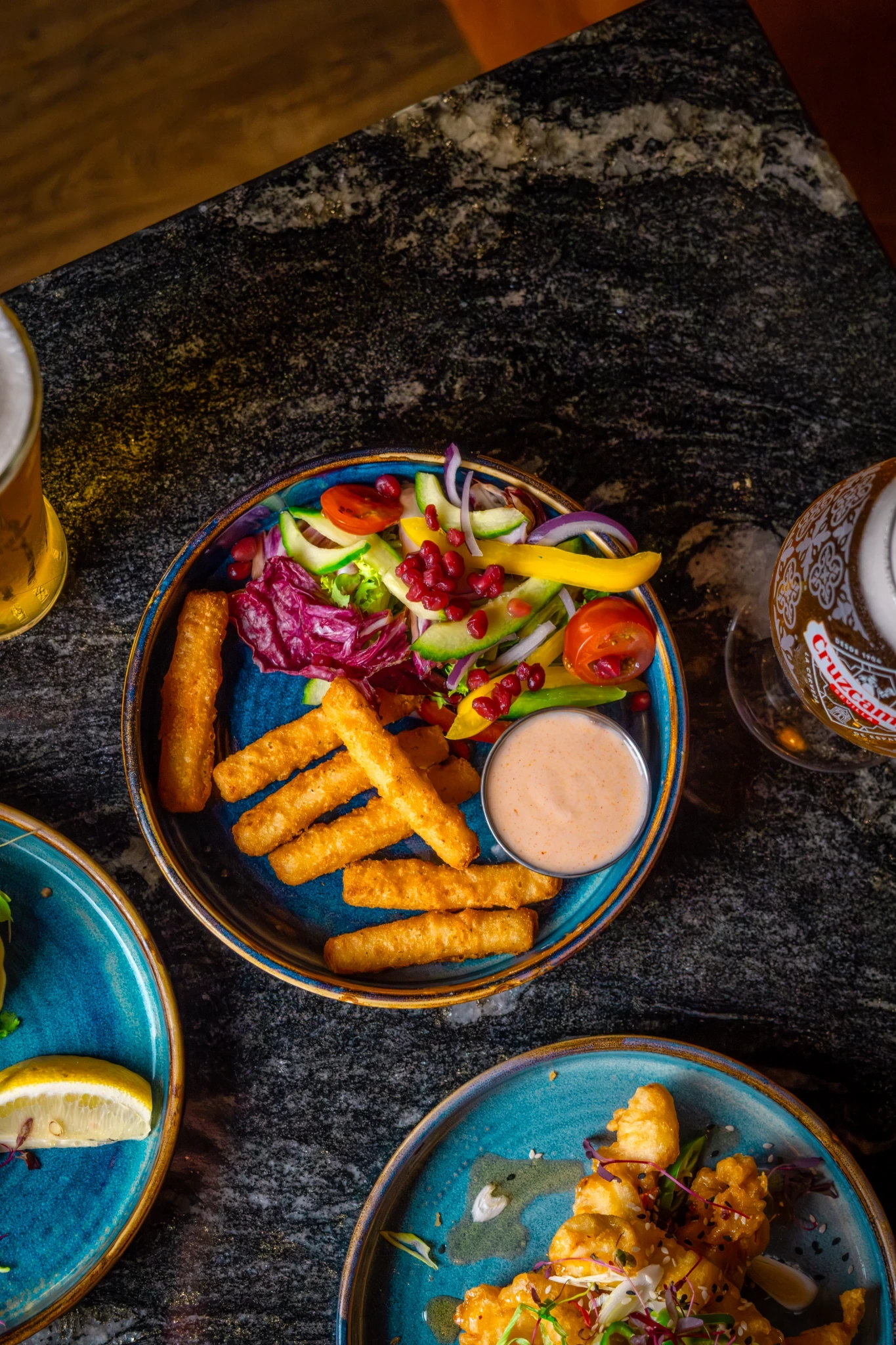 Colourful Al Bear dishes and halloumi served on blue plates