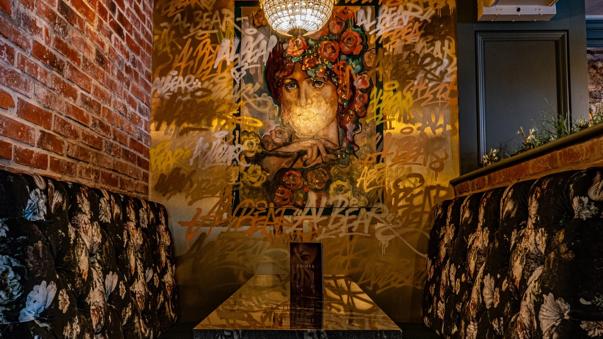 Inside Al Bear, with floral booths, artwork and chandelier